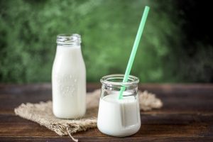 buttermilk in a glass bottle and glass