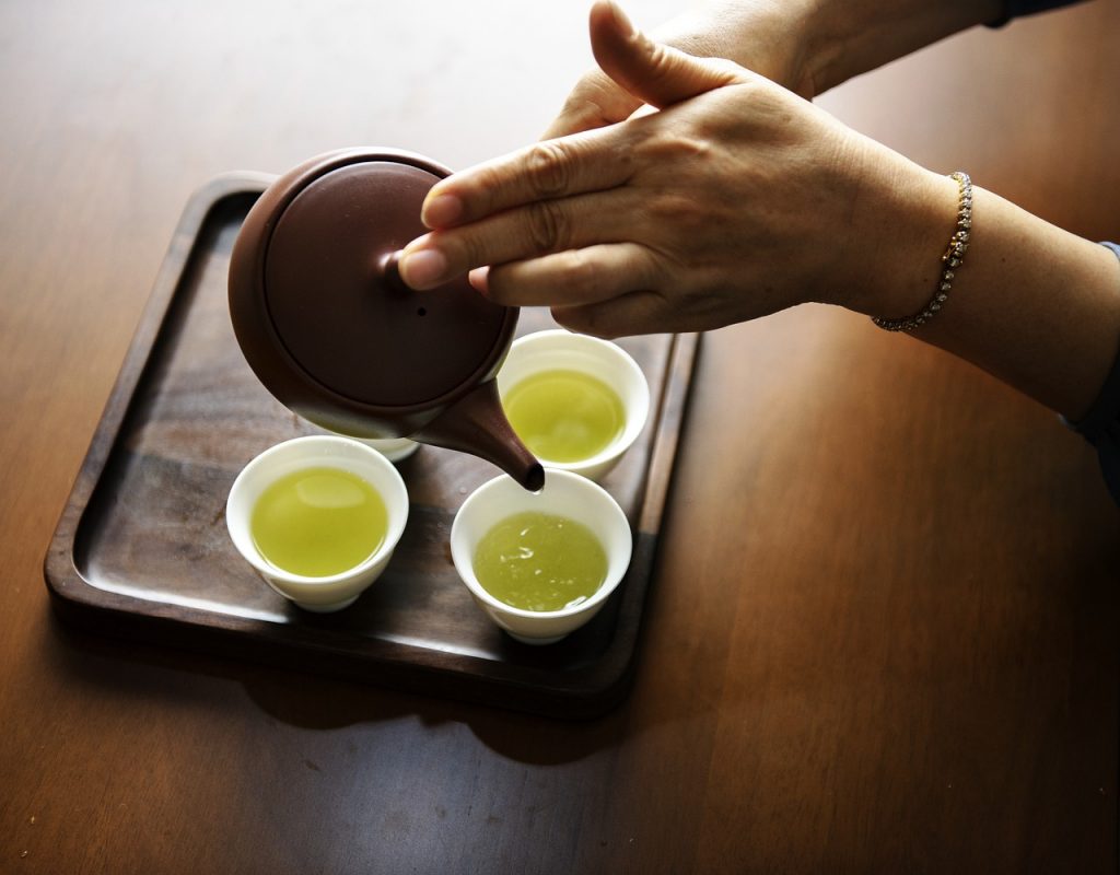 aromatic green tea is being served in tea cups