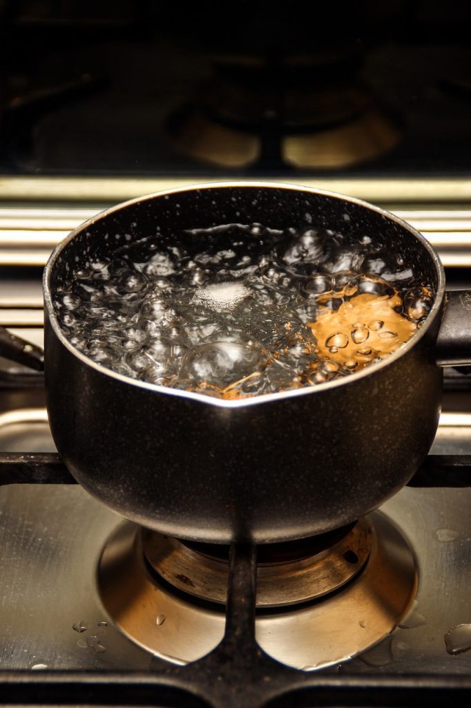 a pot of boiling water on a gas stove