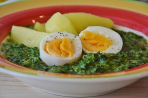 chopped spinach leaves topped with boiled egg
