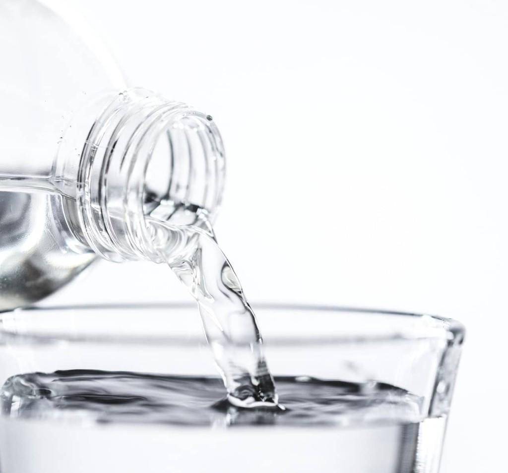 mineral water bottle pouring water in a glass