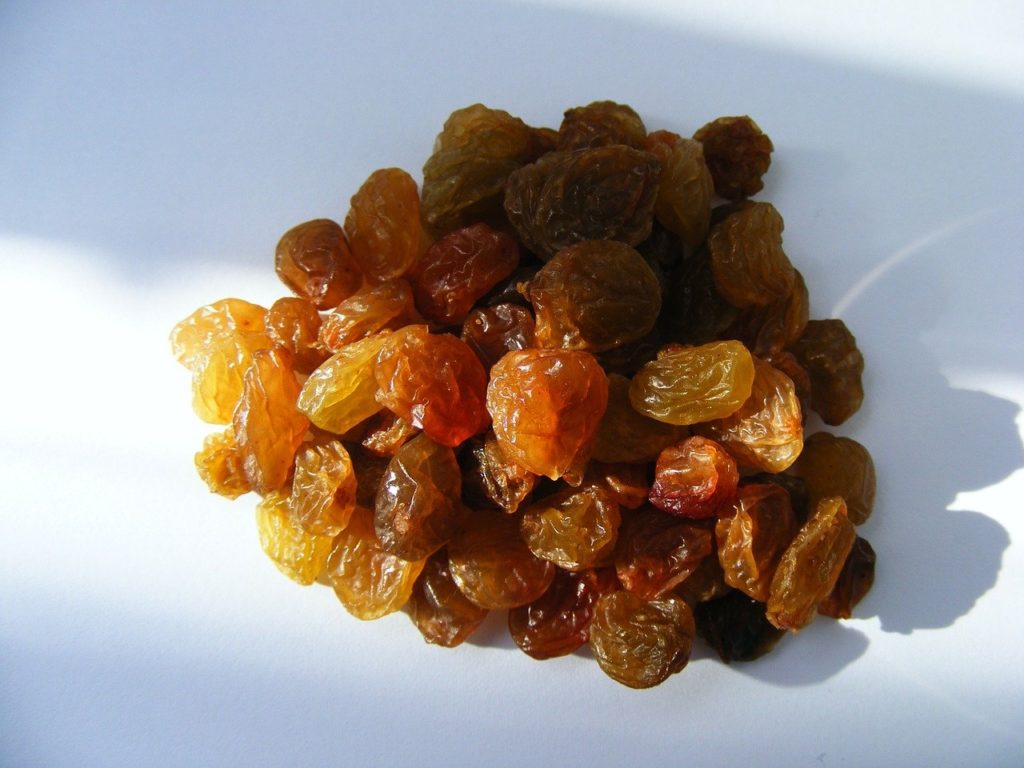 raisins collected together and kept on a white floor