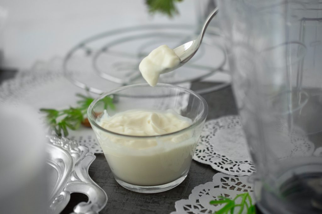 thick curd served in transparent bowl
