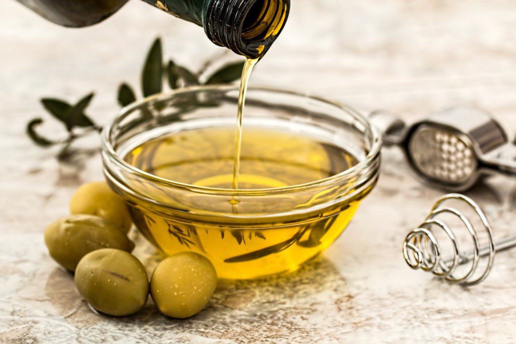 pouring olive oil in a bowl