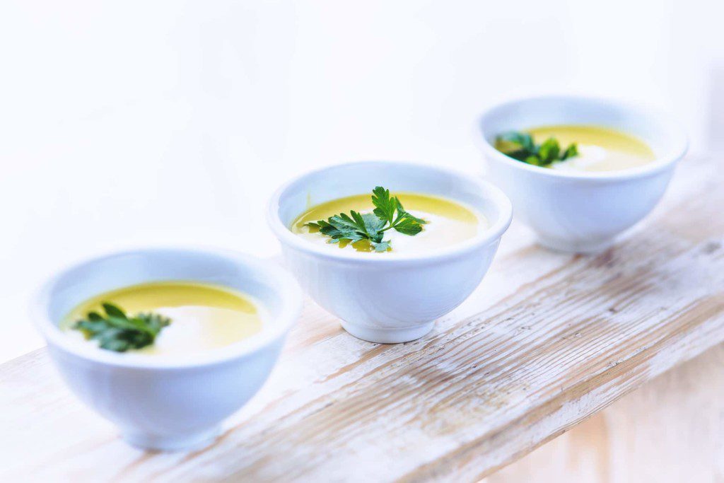 3 bowls of soup garnished by parsley