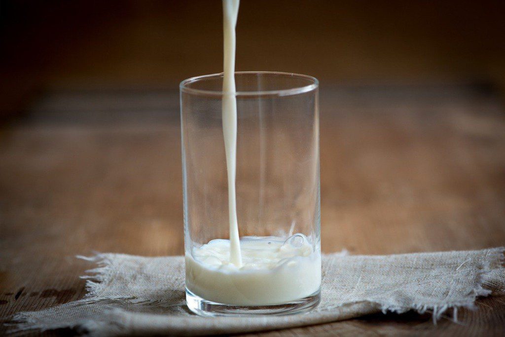 pouring milk in a glass