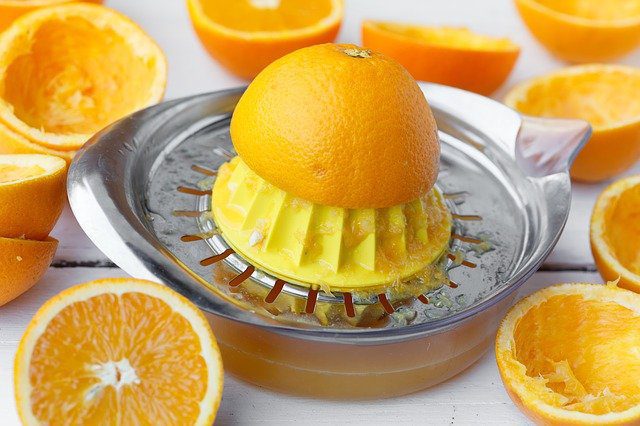 fresh orange juice in citrus squeezer