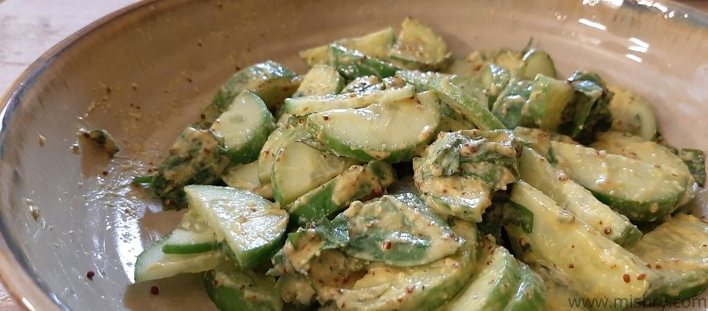 closer look at cucumber salad made using arugula and co cashew mustard salad dressing