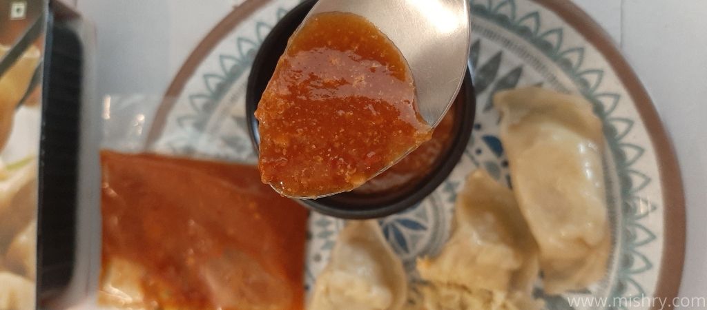 closer look at handi momos sauce in a spoon