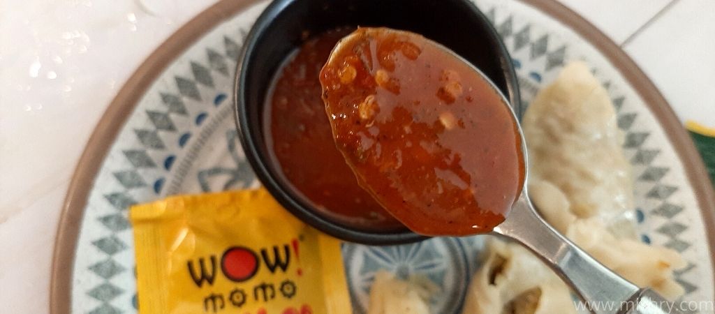 closer look at wow momos sauce in a spoon