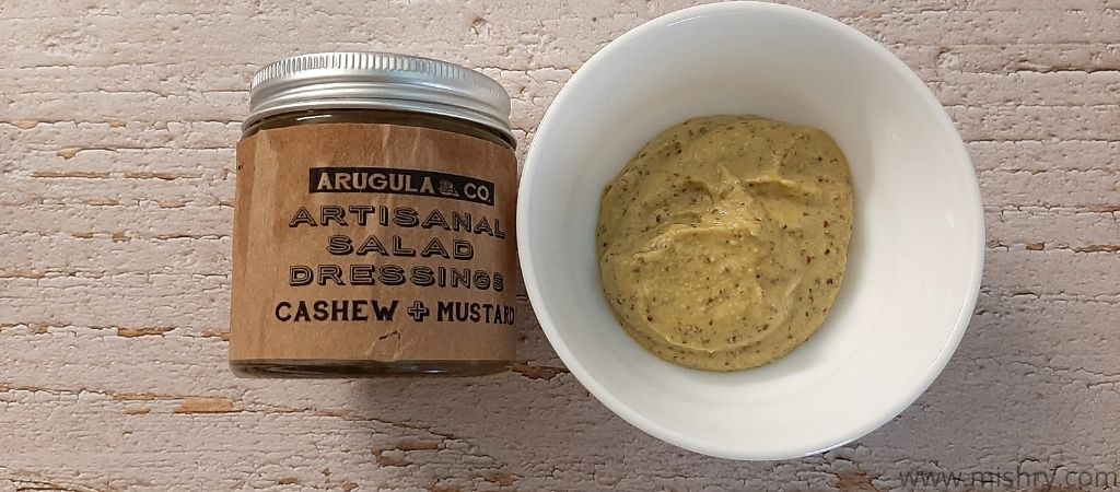 contents of arugula and co salad dressings cashew mustard bottle in a bowl