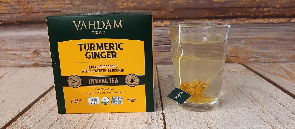 vahdam turmeric ginger herbal tea bag placed into boiled water