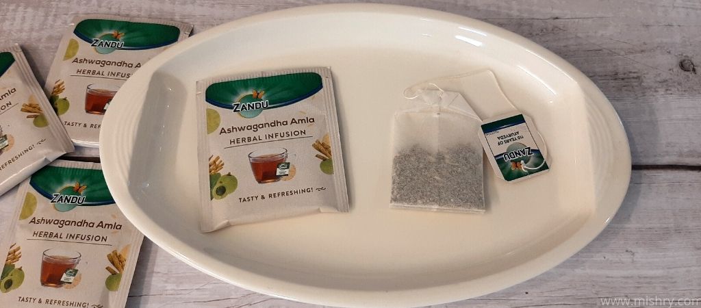 zandu ashwagandha amla herbal infusion tea bag sachet on a plate