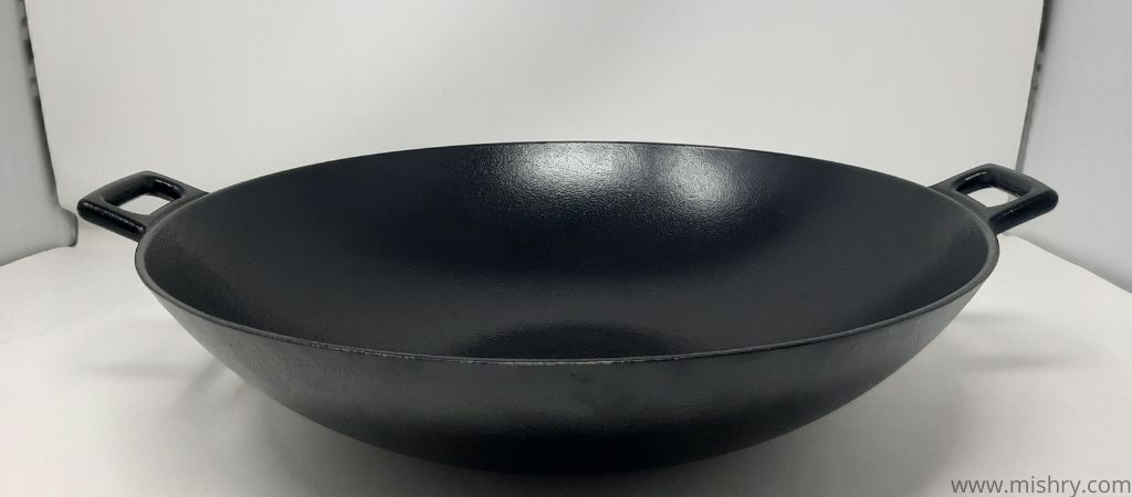 amazonbasics pre seasoned cast iron wok pan on a table