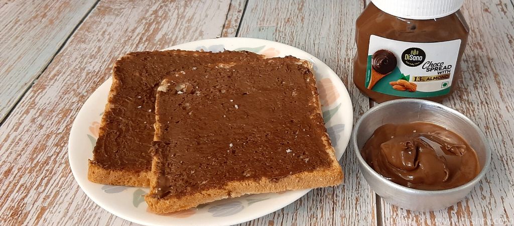 closer look at choco spread with almond over bread slices