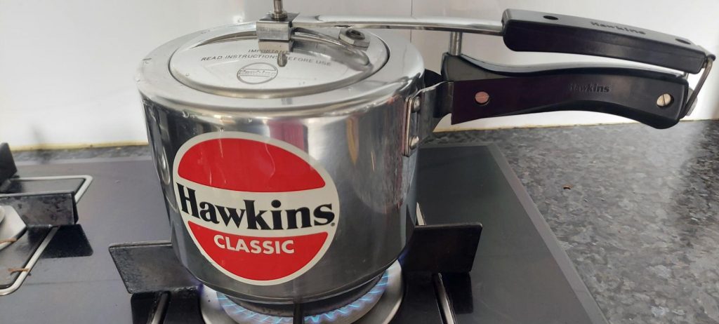 hawkins tall pressure cooker lid on stove