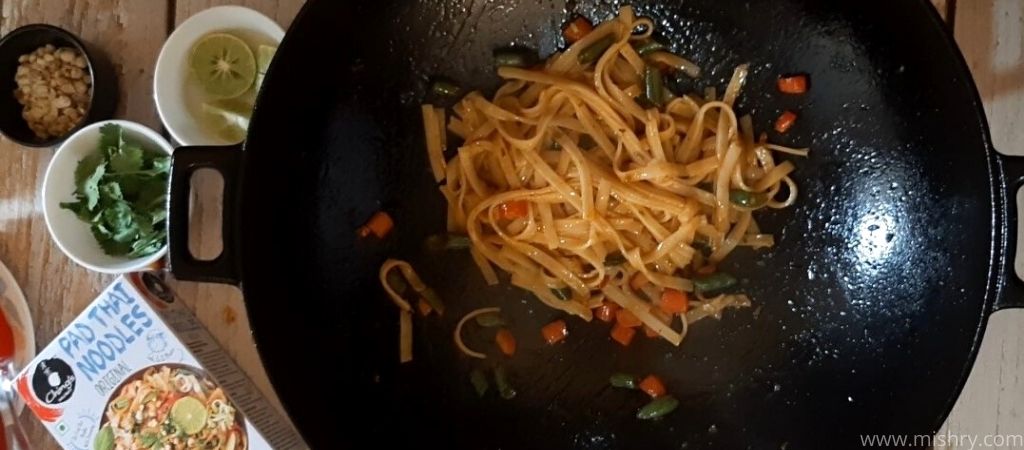 noodles frying on iron wok pan