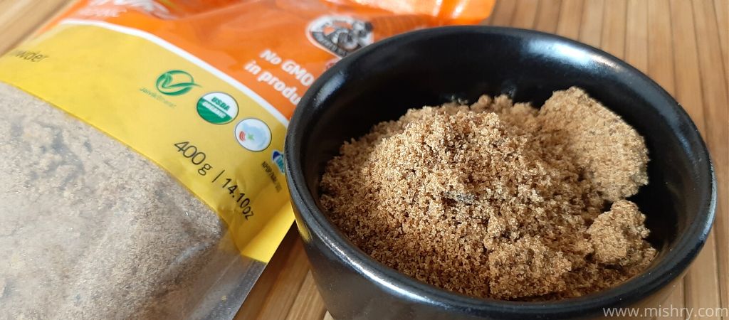 closer look at pro nature organic jaggery powder in a bowl