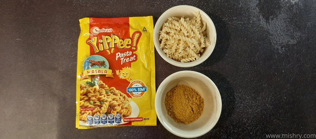 uncooked masala flavor pasta and seasoning mix placed in separate bowls
