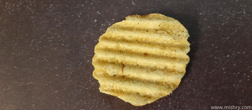 lays maxx peppery cheddar potato chips placed on a table