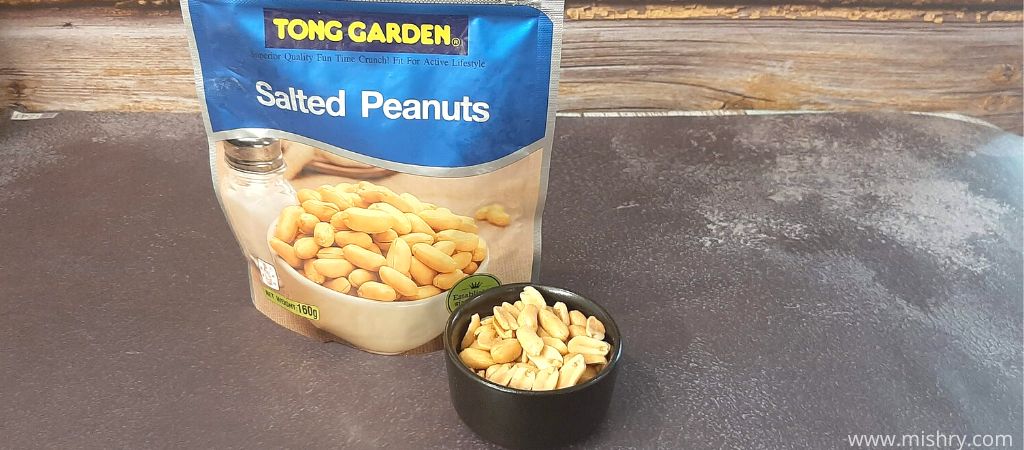 tong garden salted peanuts in a bowl